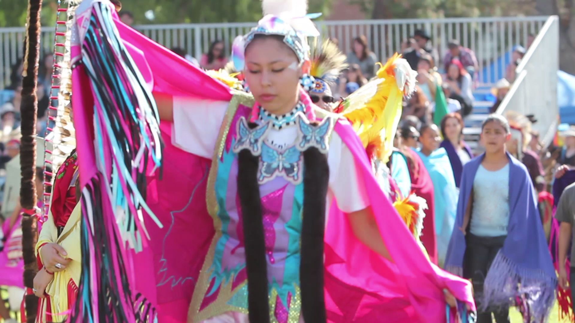 Brasileira fazendo sexo anal gostoso com dotado - A dancer in a bright pink shawl with fringe, wearing traditional regalia adorned with blue and black accents, performs at an outdoor cultural event.